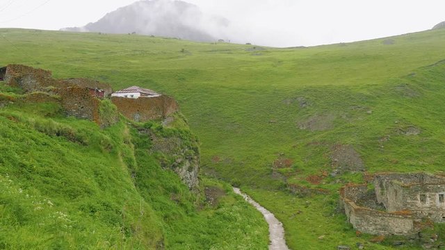 Pieces of ruined ancient mansory near mountain river