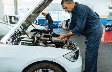 Mechanic reading the error codes with diagnostic device