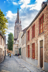 Fototapeta na wymiar Street and the Church of Our Lady in Bruges,