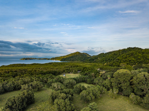 Lush forest and fertile farms border the bay and the Gulf of Nicoya and Paquera Costa Rica as viewed from an Aerial Drone image at dusk