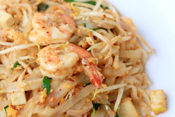 Thai style noodles, Pad Thai, stir-fried rice noodles with shrimp serve with vegetable in white plate on white background. The one of Thailand's national main dish. the popular food in Thailand.