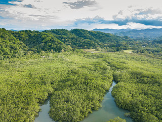 Brackish water estuaries and inlets dot the shoreline of Paquera Costa Rica as they are fed from the clear rich waters of the Gulf of Nicoya from an aerial drone view