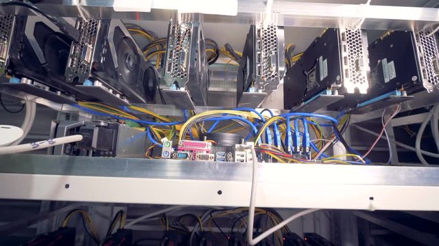 Bitcoin miners set up on shelfs. Mining cryptocurrency. Bitcoin concept.