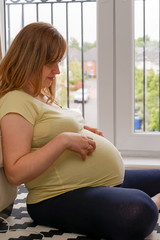 PREGNANT WOMAN WITH A BABY IN THE ROOM