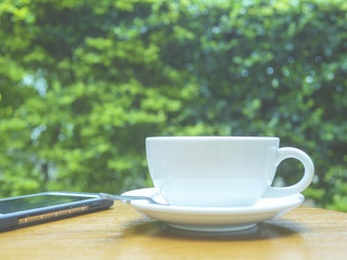 outdoor warmth and cozy day with white coffee mug in the garden 