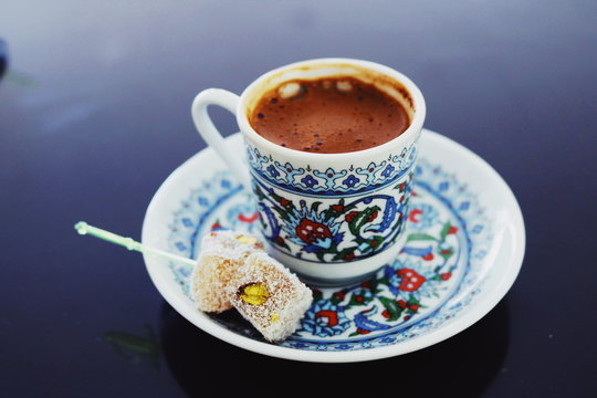 strong coffee and sweets in a cup with a well-defined pattern on a black and gray background
