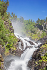 Long exposure of the right branch of the Latefossen, seen from the bridge of the main road. Due to the long exposure there is some blur in the foliage.