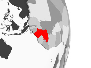 Guinea on grey political globe