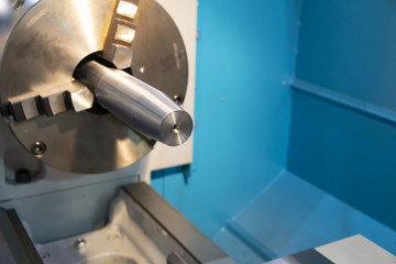 The  lathe machine cutting the steel rod.The high technology manufacturing process.