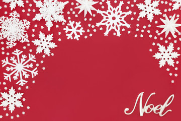 Christmas noel sign and white snowflake decorations on red background. Traditional Christmas greeting card for the holiday season.