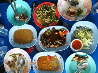 finish and done Thai spicy food, Somtum, Papaya salad with empty dish on the wooden table on family day