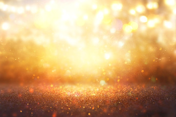 Obraz na płótnie Canvas blurred abstract photo of light burst among trees and glitter golden bokeh lights.