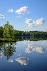 Fototapeta premium Sky reflects from still lake at summer day