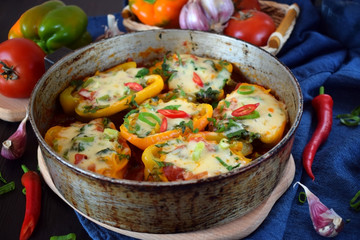 Stuffed halves of bell peppers with mince and cheese in a frying pan. European and Caucasian cuisine meal
