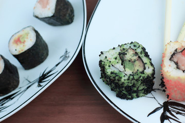 Roll of sushi prepared from raw fish and a special rice