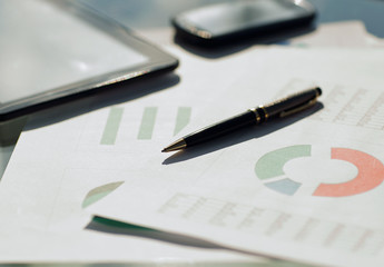 Financial paper charts and graphs on the table