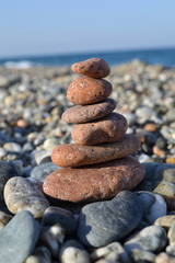 Fototapeta na wymiar Colorful sea pebbles - Beautiful round stones on the beach