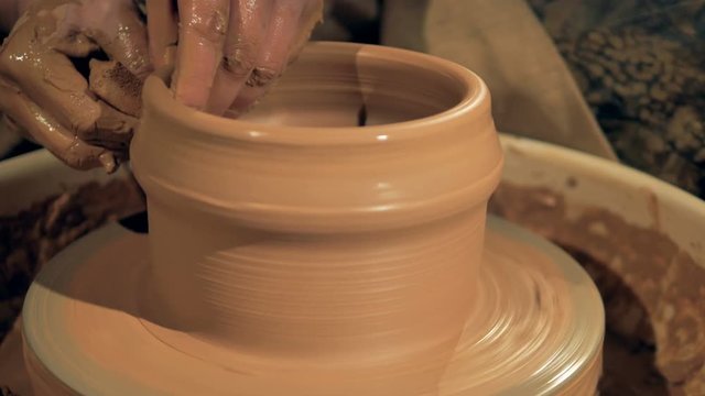 A process of jar making, close up. Jar molding on a pottery wheel.