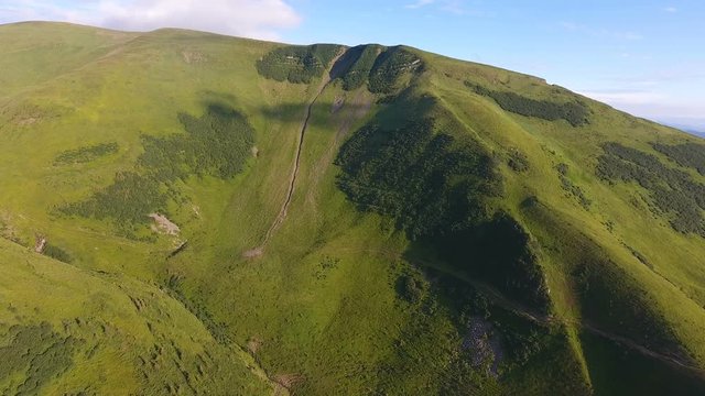 Aerial of rugged and concave slope with hollows and gaps in the Carpathians
