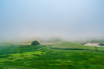 Foggy green landscape at the bottom of the cauldron of Corvo Island in Azores