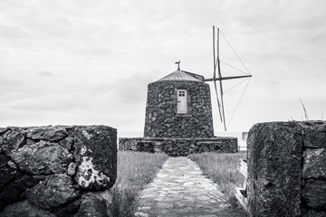 A windmill in Corvo Island Azores, on a cloudy day