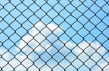 Fototapeta na wymiar cage metal wire wall on blue sky