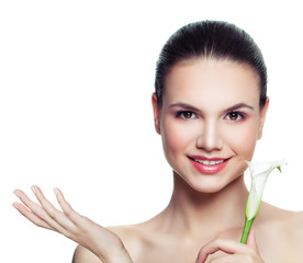 Healthy woman with cute smile and flower showing empty copy space on the open hand isolated on white background. Presenting your product