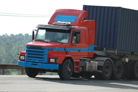 no brand red and blue old semi truck with blue container