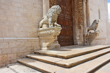 Italy, Puglia region, Altamura,  Cathedral of Santa Maria Assunta, gate and sculptures of the main façade. Medieval steps at the entrance