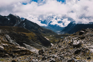 Fototapeta na wymiar Himalayas mountains. Lake in the mountains, rocks in clouds. View on the lake Gokyo Ri not far from Everest. Colorful landscape with beautiful rocks and dramatic cloudy sky. Nature background.