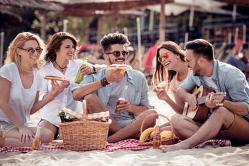 Group of friends having a party on the beach
