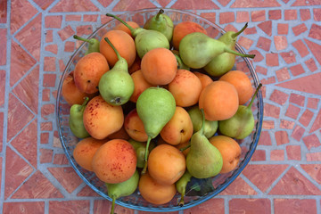 Italy, Typical fruit of the summer season, pears and apricots.