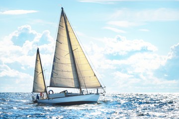 Vintage wooden two mast yacht (yawl) sailing in a open sea on a clear day