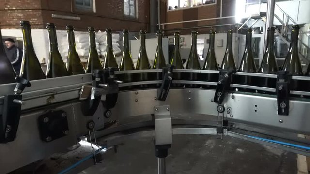 Bottling and sealing conveyor line at winery factory
