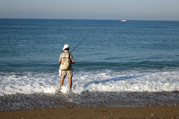 Fisherman fishing on the sea coast.