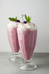 Cherry milkshake with whipped cream and cherries