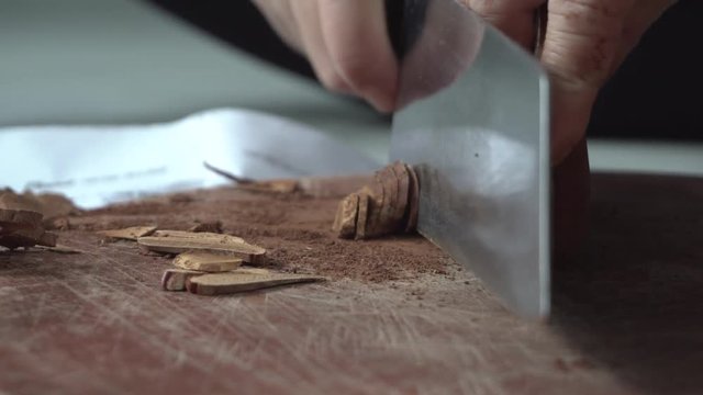 woman hand use knife cut ganoderma into piece