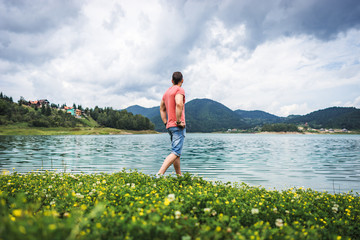 One man standing alone on Zaovine lake in Serbia relax, and feel freedom