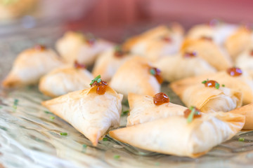 Filo pastry parcels on a glass plate.