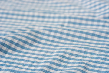 folded blue and white checkered fabric background