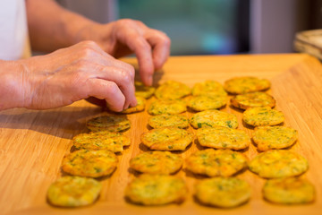 Close-up of a woman's hands making fritters.