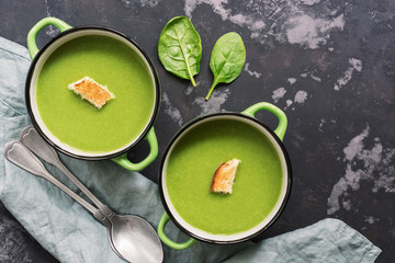 Cream of soup with spinach on a rustic background. Top view,flat lay. Green soup.