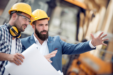 Two engineers going through routine checks