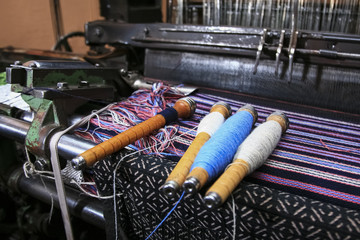 weaving loom at a textile factory, closeup. industrial fabric production line