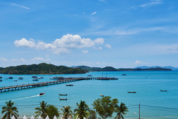 Pier speedboat. A marina lot.  Popular tourist attractions on the beach. Yacht and sailboat is moored at the quay. Aerial view. Yacht berth at the  harbour marina in tropical Island.