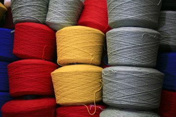 coloured spools of yarn wound onto cones