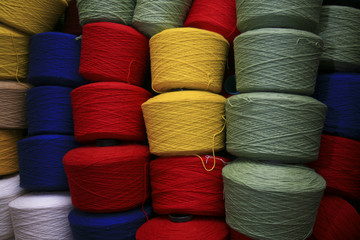 coloured spools of yarn wound onto cones