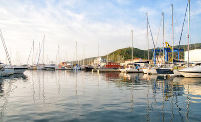 Fototapeta na wymiar Harbor with yachts and sailboats at sunrise