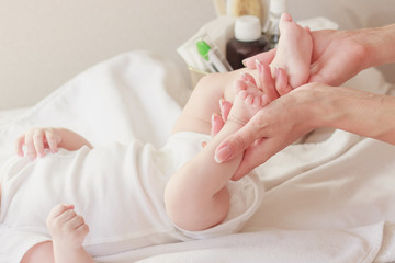 Body of a baby and hands of mother, soft focus background