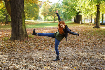 Carefree young redhead woman in a park